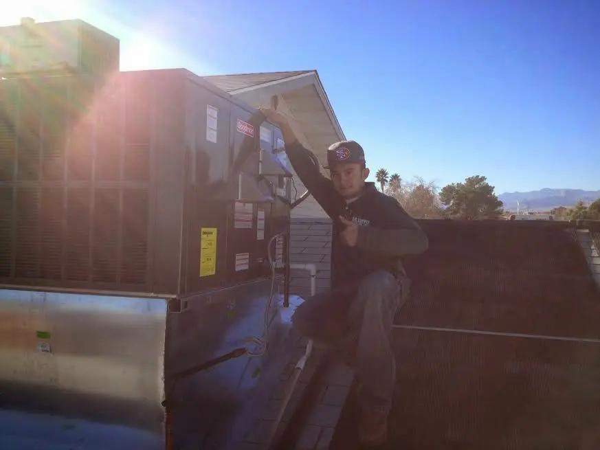 HVAC technician performing HVAC Inspection on a rooftop unit in Clemson
